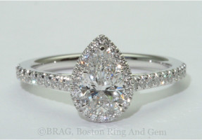Pear shaped diamond set in a fishtail set pear halo on a cathedral band 