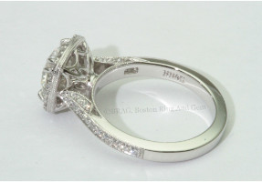 Round brilliant cut diamond set in a vintage inspired halo on a bead set mill grain cathedral band.