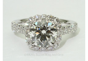 Round Brilliant cut diamond set in a cushion V prong halo on a French cut set Cathedral band.