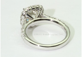 Round Brilliant cut diamond set in a cushion V prong halo on a French cut set Cathedral band.