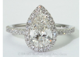 Pear cut diamond set in oval halo on a none cathedral French cut set band.