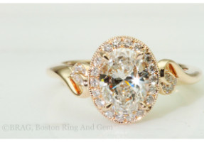 Oval brilliant cut diamond set in rose gold halo with leaf detail cathedral band