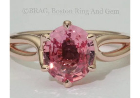 Padparadscha sapphire set in a 6 prong twisted 14k rose gold ring.