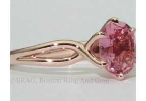Padparadscha sapphire set in a 6 prong twisted 14k rose gold ring.